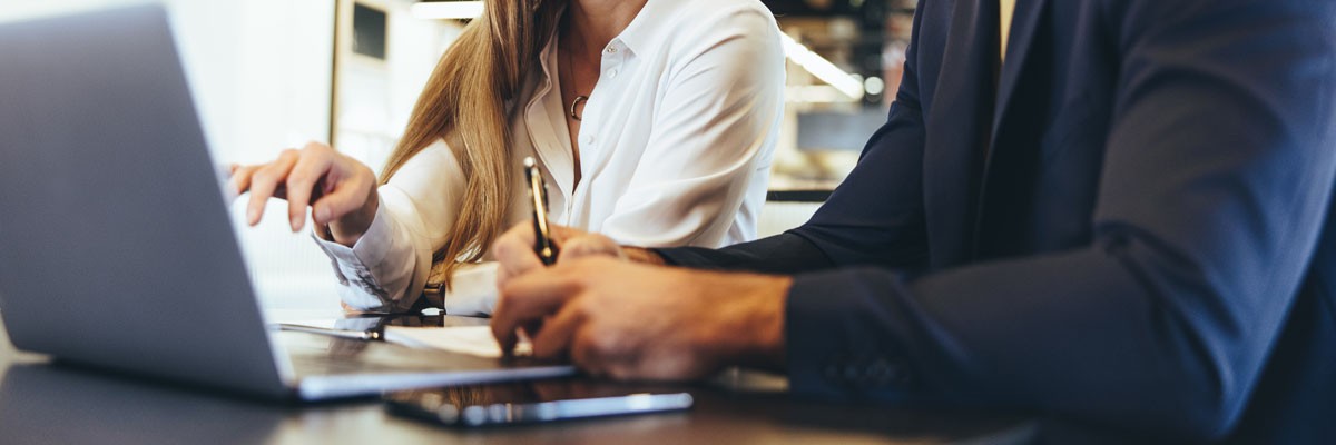 Water, Hygiene, and Energy Services Company Sees Cost Savings With Device Fleet Support Businessman and woman collaborate on laptop device in office