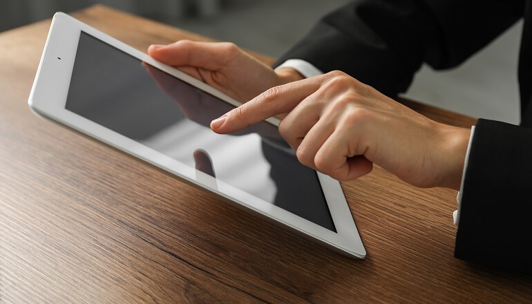 Person on tablet clicking on screen