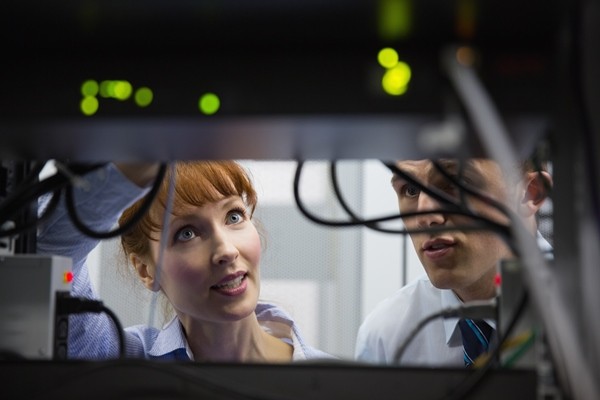 Male and female IT workers working in Data Center.