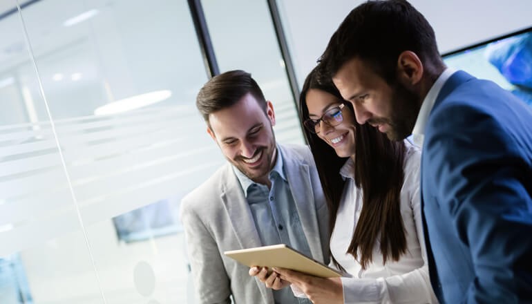 Business team sharing tablet