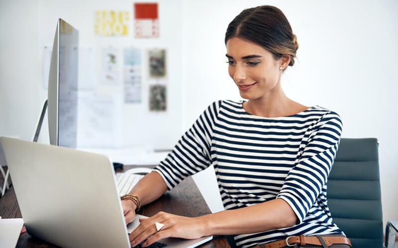 Smiling business woman on laptop computer