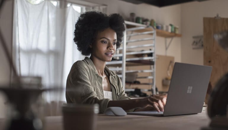 Small business professional using Microsoft Surface Pro with Windows 10