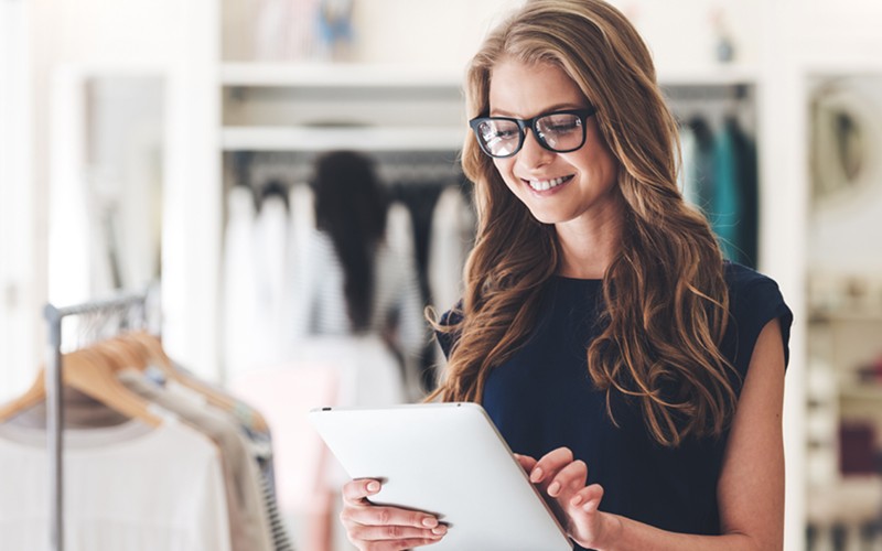 Retail employee checking inventory on tablet computer. Enhanced customer and employee satisfaction