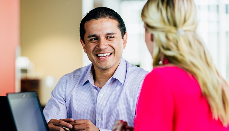Manager talking with employee in candid meeting