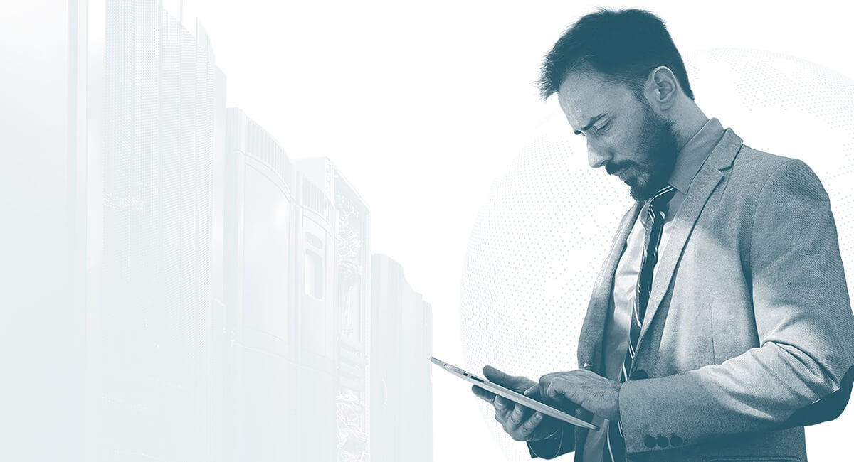 3 Key Advantages of Using SD-WAN to Transform Your Network Man in business suit looking down at computer tablet