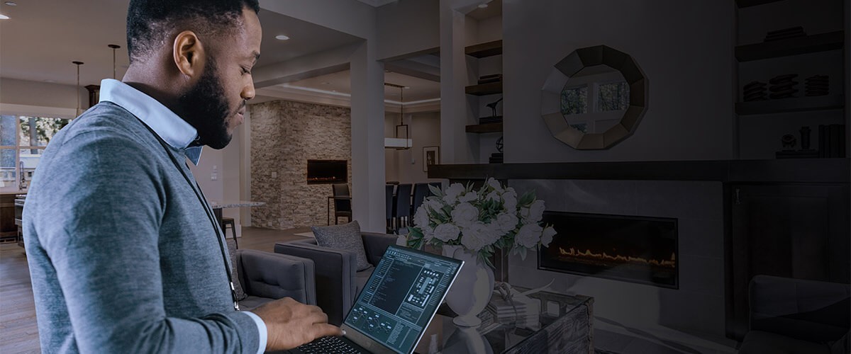 Business professional working off laptop computer at home.