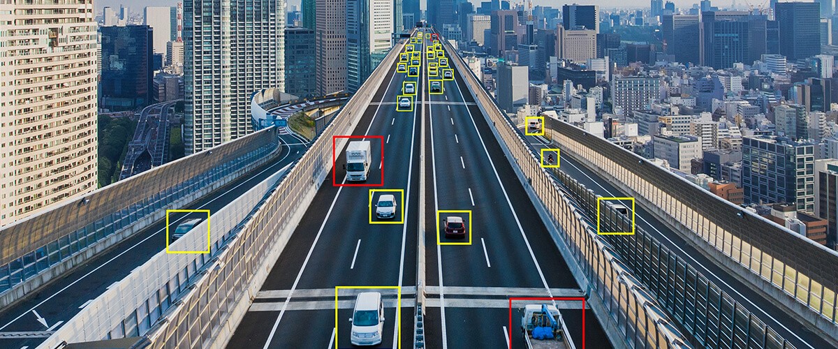 Smart cities leverage innovations in data and Artificial Intelligence (AI) to foster public safety. Camera detecting car and traffic from over bridge overpassing. smart cities, smart city technology, public safety technology