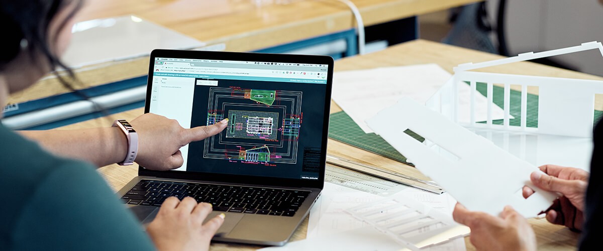 Woman points at computer screen showing what appears to be a computer processor diagram