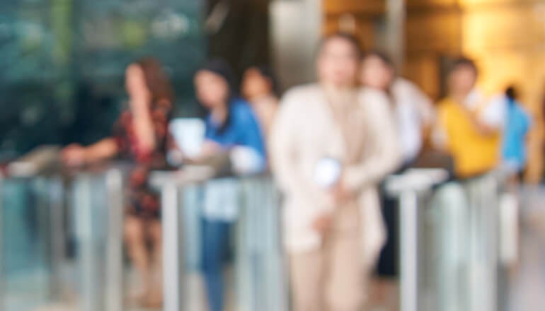 Business professional on laptop computer at work. Return to work. Return to work strategy. Artificial Intelligence for safety. IoT for safety.