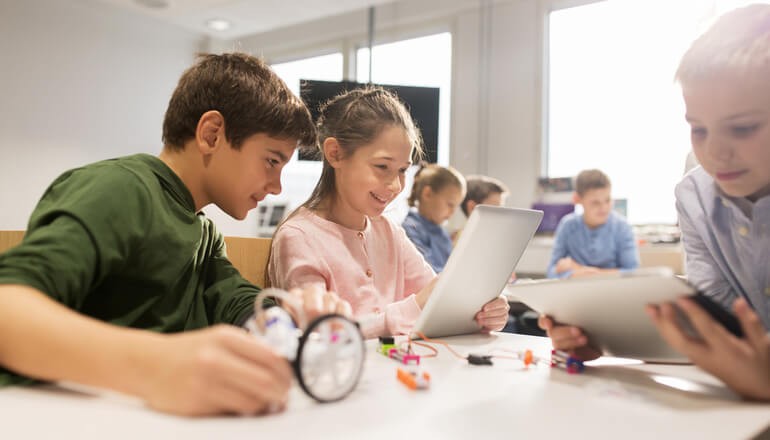 Two young students learning in classroom