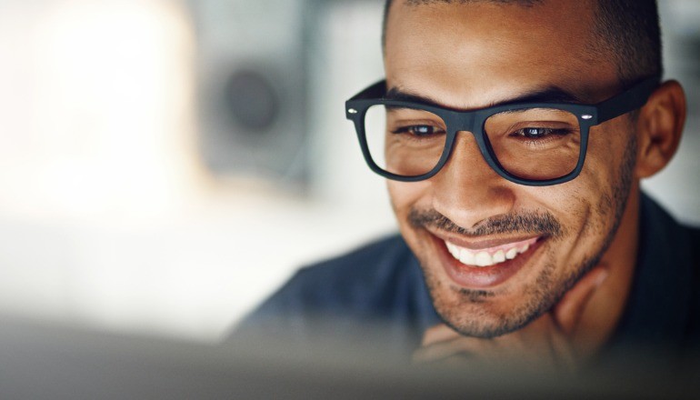 Man smiling at desktop