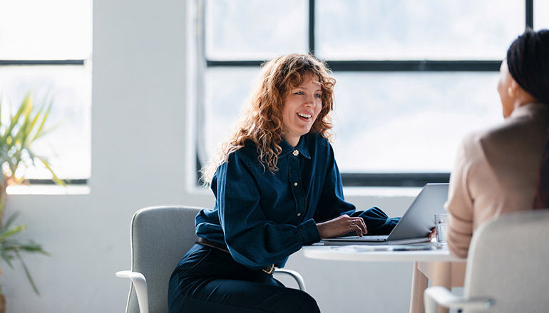 Microsoft licensing changes webinar Woman smiling on laptop in meeting