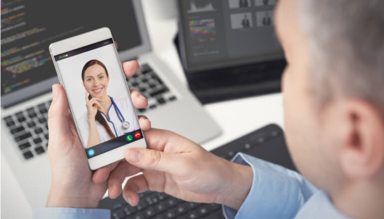User using mobile device with doctor