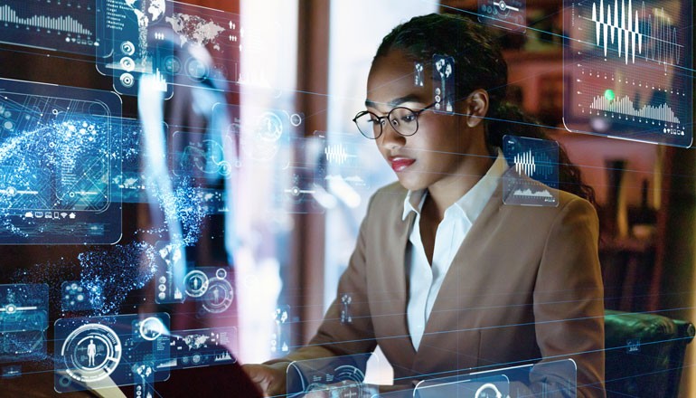 Abstract concept of data overlaying businesswoman on laptop computer