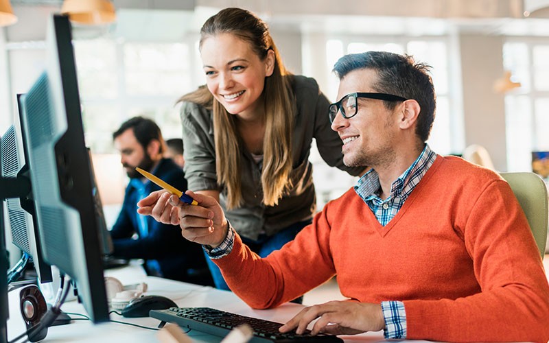 Man teaching his co-employee