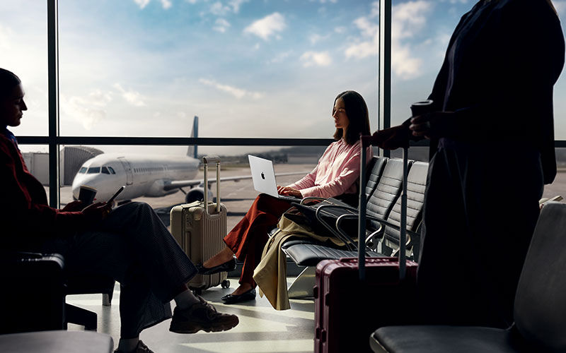 Woman working on laptop at coffee shop