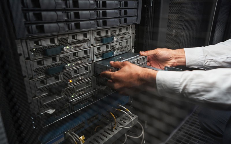 Cisco designs, validates and optimizes its converged infrastructure offerings Close of hands pulling a server out of a rack