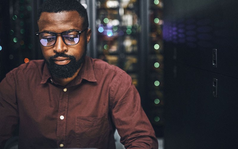 Create a single management domain for your UCS chassis, blade servers and rack servers View of man working in server room