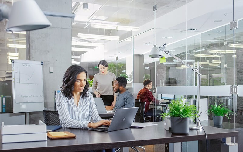 Businesswoman working on her laptop in a modern office