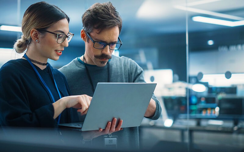 Two person with glasses working together