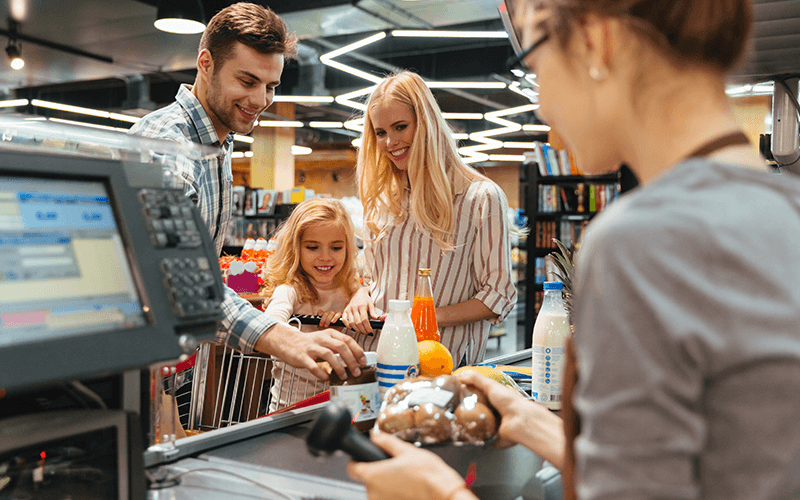 Woman taking customer products to scan