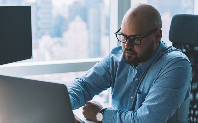 Business team surrounding tablet device
