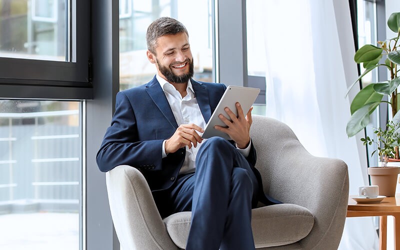 Man in suit using his tablet