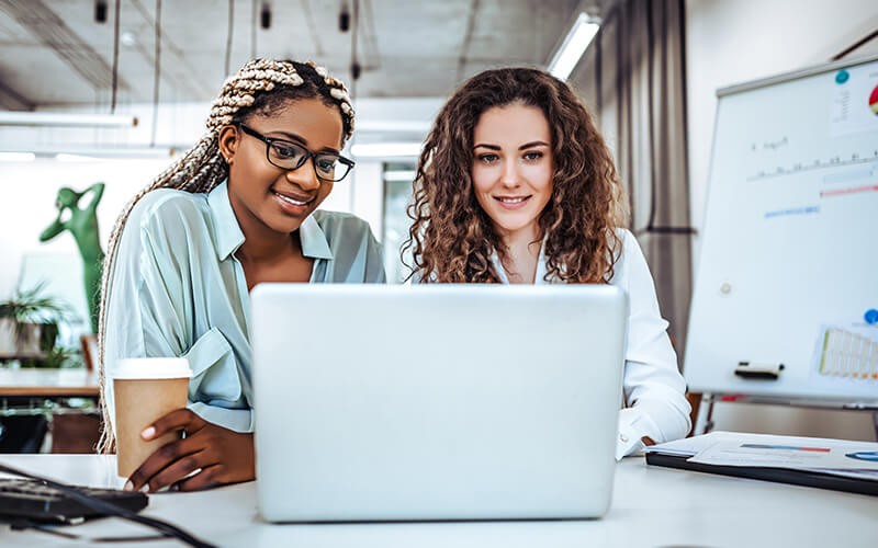 Teammates working together using a laptop
