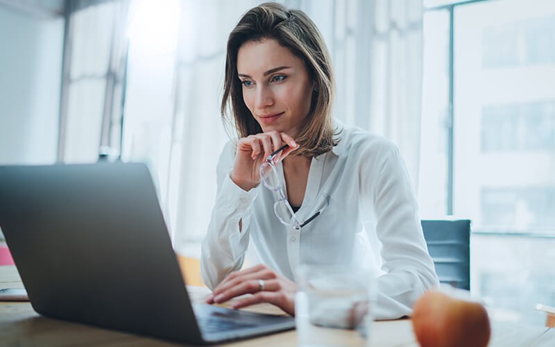 Woman in glasses using a laptop