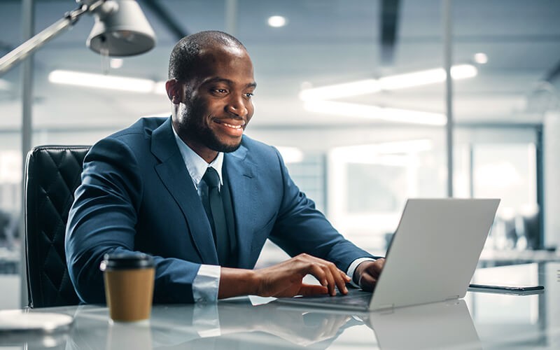 Man in suit using his laptop