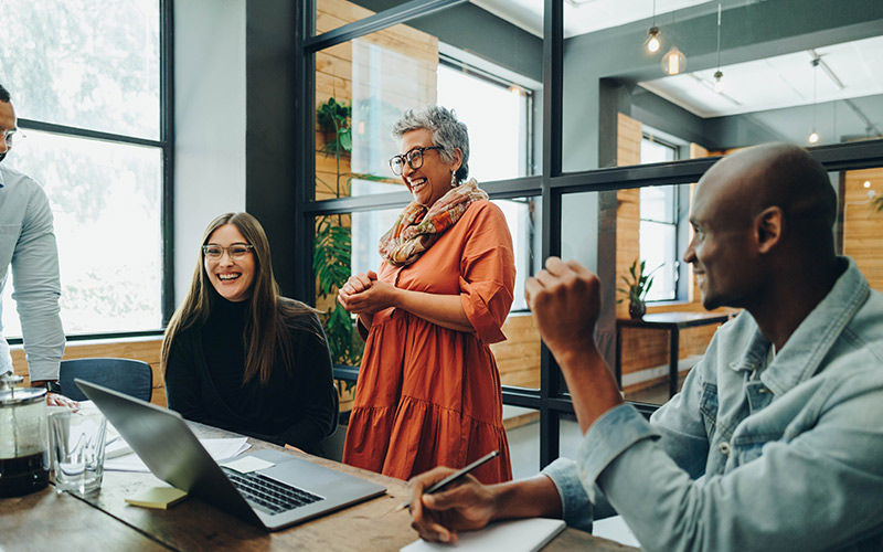 team-collaborating-meeting-room-smiling-is1395144844