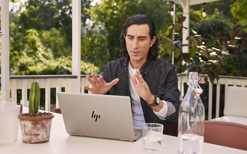 Man using a HP laptop outside