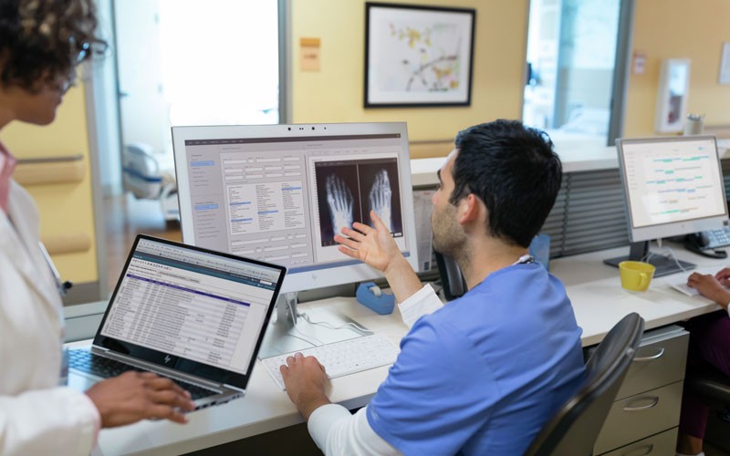 Two doctors at nurses station