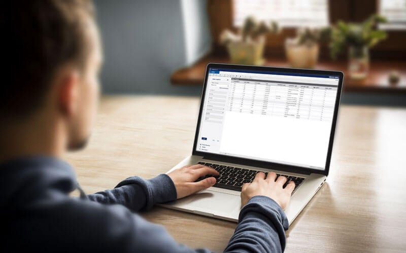 Male using laptop displaying Axiom Pro software