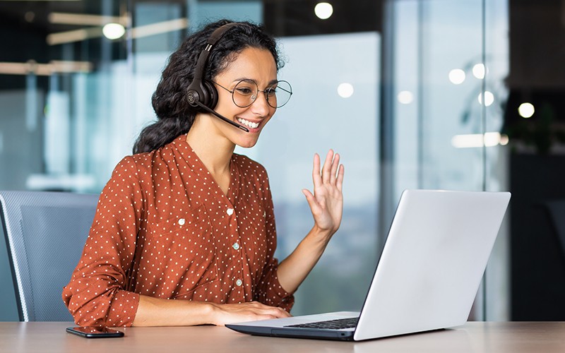 Woman using a laptop with headphone
