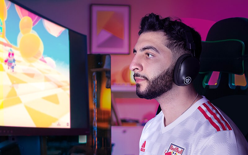 Man playing using JLab headphones