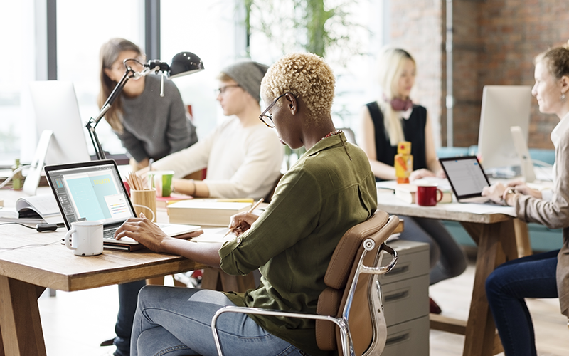 Teammates collaborating in workplace