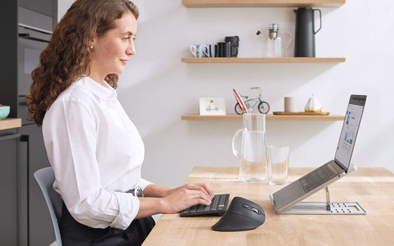 Person using two monitors at work