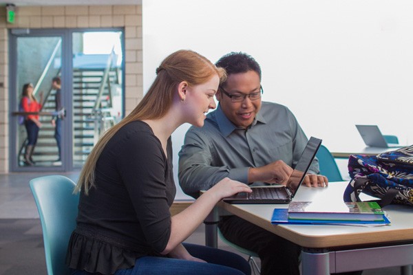 Inspire by incorporating mobile devices into your learning environment Teacher helping student out with assignment