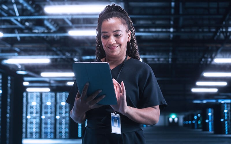 Woman standing holding her tablet