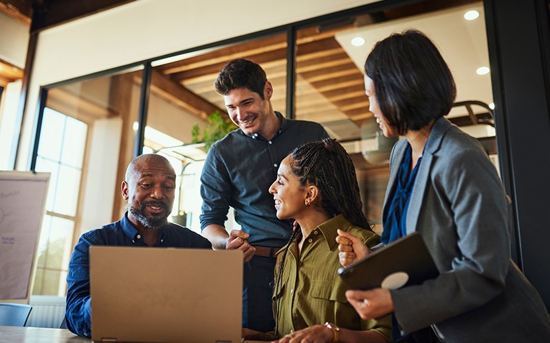 team-working-around-table-in-office-smiling-lifestyle