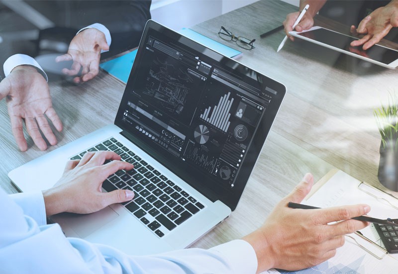 Close-up of business man hands using laptop device and data management system