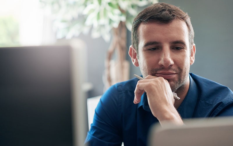 Business man looking at desktop screen