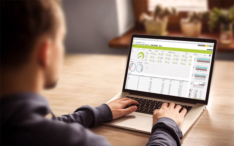 User on laptop device that displays Paessler software on screen