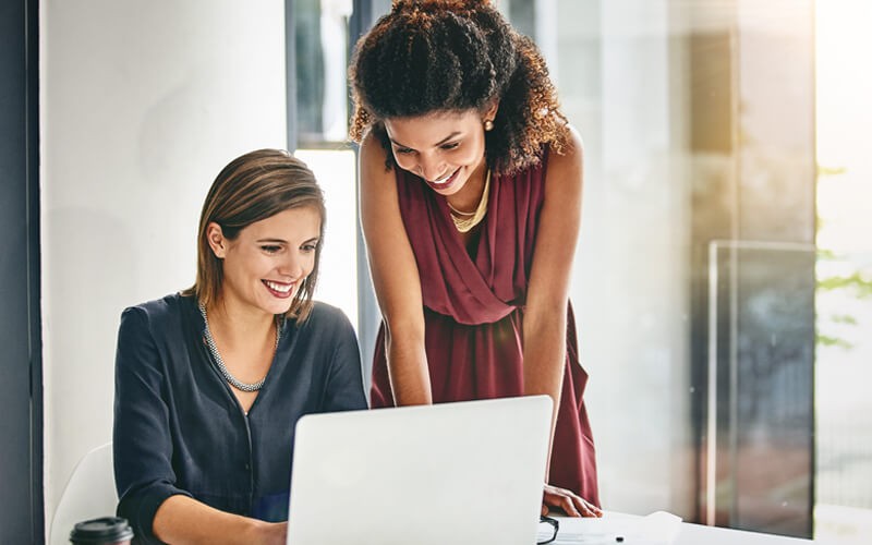 Women collaborating over laptop