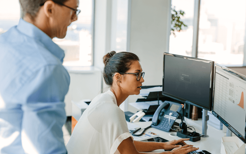 Male and woman looking at desktop