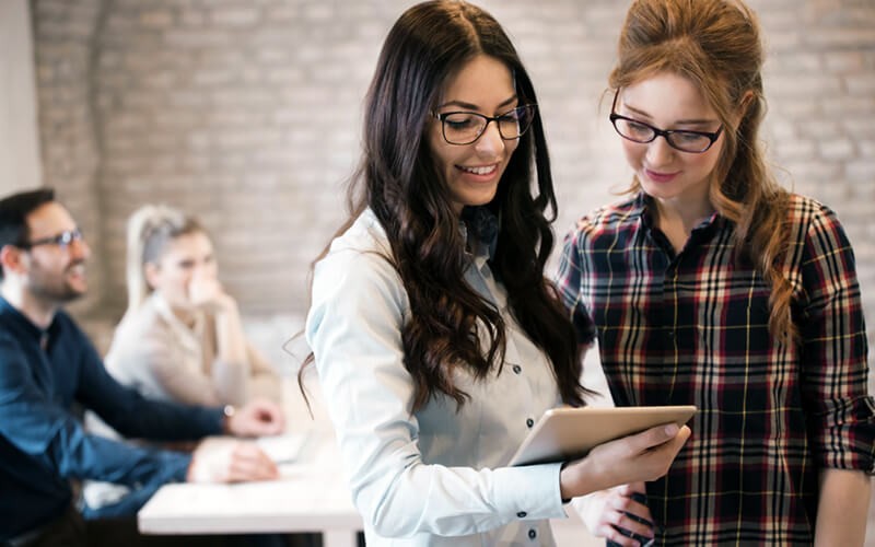 Two woman looking at tablet device