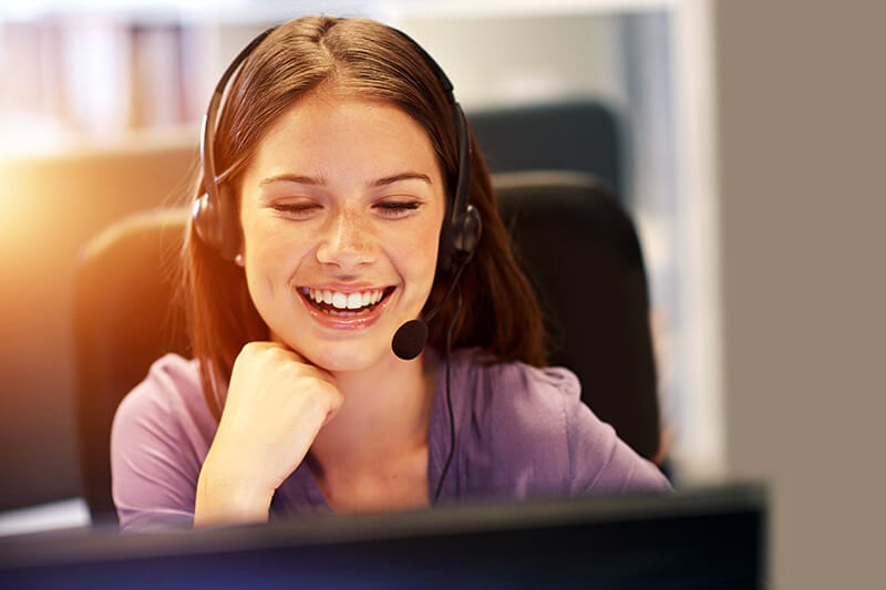 Red Hat provides 24/7, award-winning customer support Smiling call center representative with headset in office