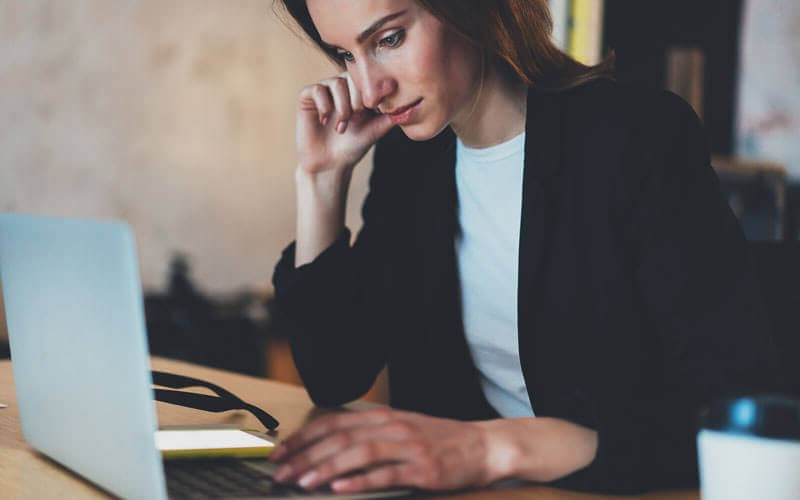 Businesswoman focusing on work with laptop computer on desk