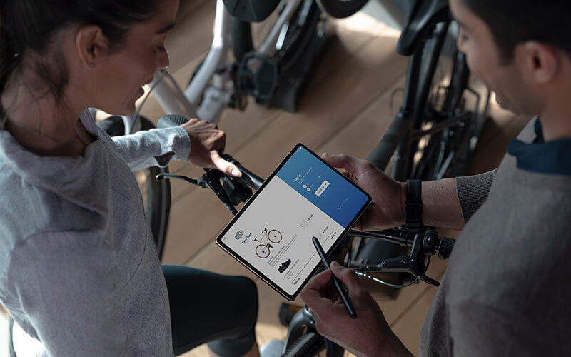 Two colleagues talking to each other about the bike